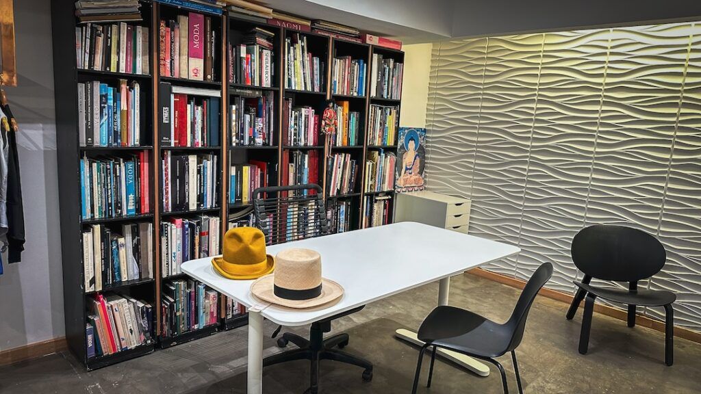 Taller de la tienda: estantes con telas y una mesa de trabajo